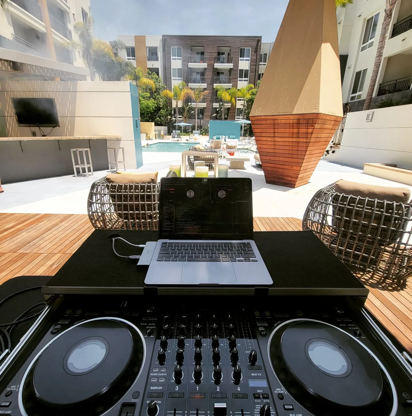 Poolside DJ setup on a rooftop deck at a luxury apartment party