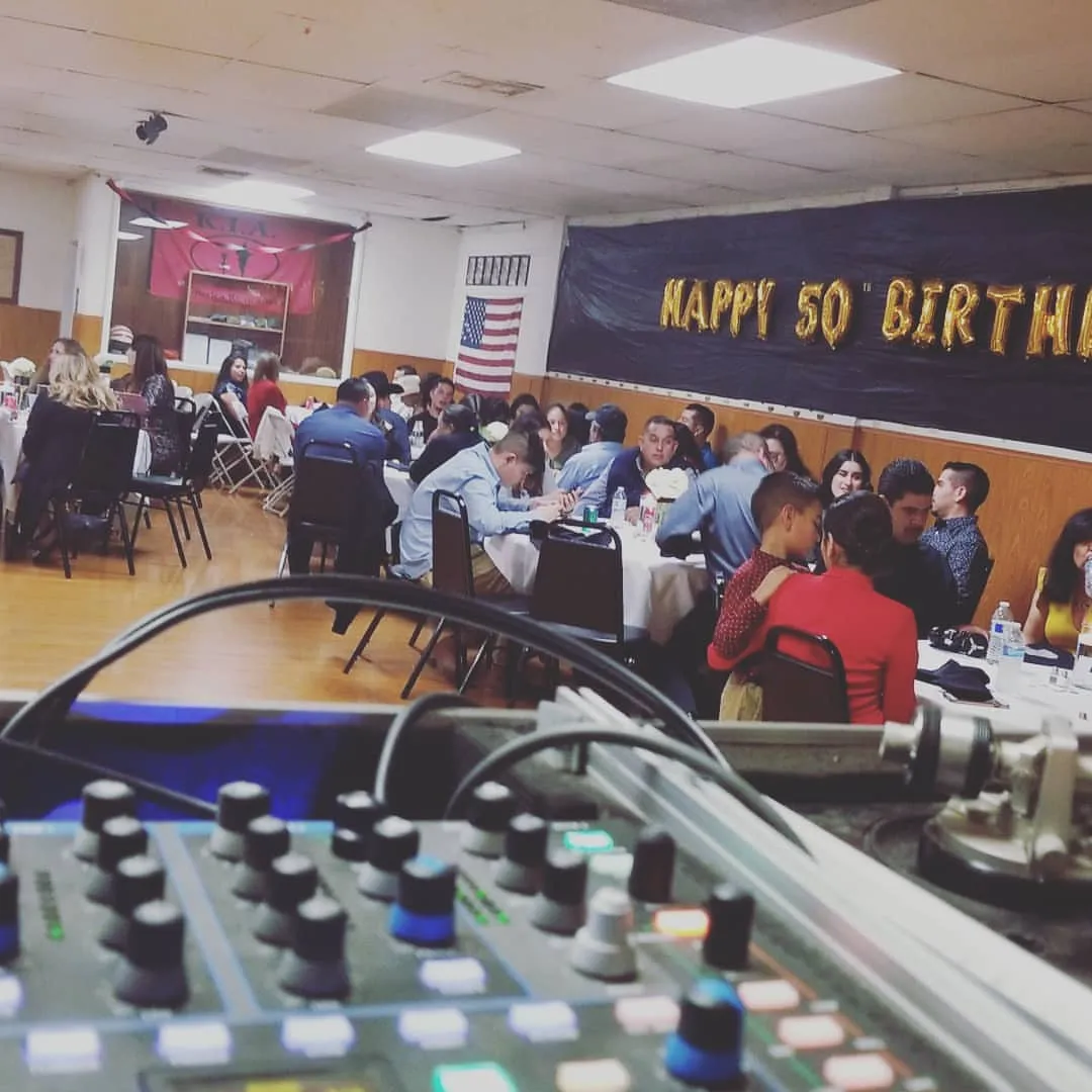 Happy 50th Birthday banner across a hall above the mixer